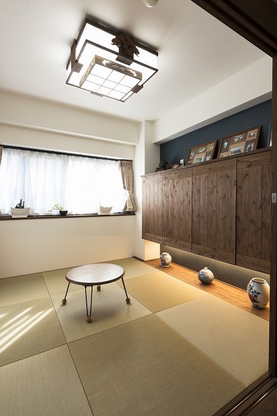 ダイニングと繋がる和室。布団の収納する扉を無垢材で造作し、リビングから見えても違和感がないようにデザインに。天井に見えるのが、奥様のご実家から取り寄せたかった懐かしい照明。 ダイニングと繋がる和室。布団の収納する扉を無垢材で造作し、リビングから見えても違和感がないようにデザインに。天井に見えるのが、奥様のご実家から取り寄せたかった懐かしい照明。