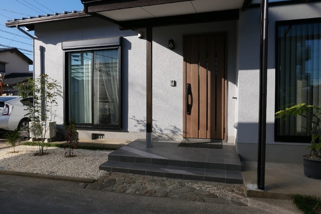 外壁はグレーにサッシは黒、玄関タイルなどの色味も揃えました。<br />
植栽も相まってモダンな佇まいです。